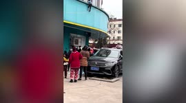 Chinese residents catch girl falling from first floor of building with quilt