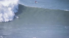 Surfers battle to stay upright as huge waves approach Portugal's Nazare