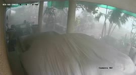 Strong wind pushes away car during storm in Thailand