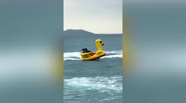 Hilarious moment man is thrown into sea from inflatable raft towed by jet ski in China