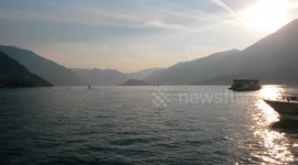 Sunset on Como Lake, Bellagio. Italy. Boats and ferry.