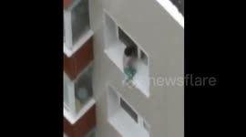 Video captures toddler playing on eighth-floor window sill