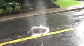 Heavy rainfall nearly blows manhole cover out of the ground