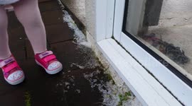 Girl plays in hail