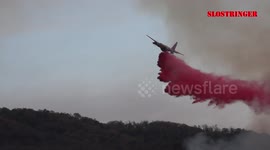 Plane dumps retardant over California fire