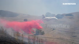 Firefighting plane swoops low over California wildfires