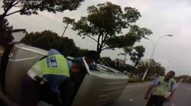 Bus driver stops to help rolled over minibus