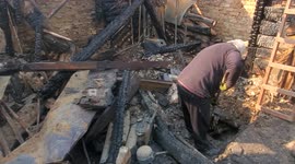 Burned Home in Kyiv after Shrapnel from Russian Shell started Fire. Resident cleans the remains.