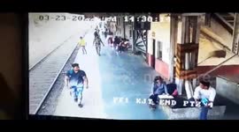 Indian security personnel saves young adult who jumped in front of train in western India.