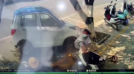 Mobility vehicle narrowly misses woman after smashing into tree on pavement in China
