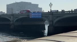 PETA activists drop a huge banner on Westminster Bridge calling out the Ministry of Defence for use of bear fur in guards’ caps