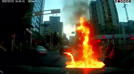 Trail of fire follows burning car leaking petrol on road in China