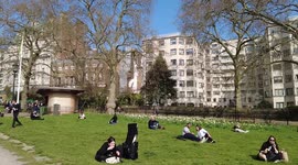 People out to enjoy the sunshine at Green park, London, UK