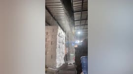 Heavy rain leaks through warehouse roof in Thailand