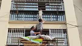 Chinese man risks life to rescue 4-year-old boy hanging from fourth-floor window