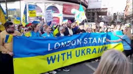 sadiq khan poses for photographs with a huge london stands with ukraine banner