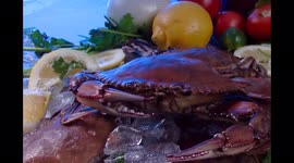 fresh crab with vegetables and ice on a table ready for cook