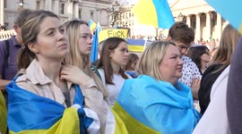 Women standing in a crowd, watching the London Stands with Ukraine: March and Vigil stage
