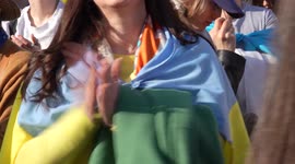 Front view of a woman clapping at Trafalgar Square for the London Stands with Ukraine: March and Vigil