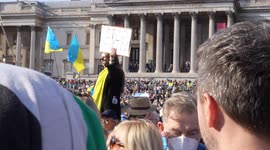 Man with placard in crowd at London Stands with Ukraine: March and Vigil in Trafalgar Square