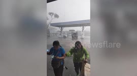 Terrified staff run to safety after thunderstorm batter gas station in Thailand