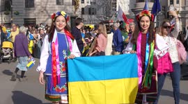 Two young girls holding Ukraine flag at the London Stands with Ukraine: March and Vigil