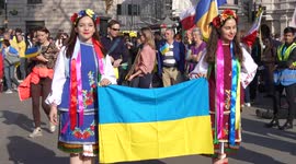 Two girls holding Ukraine flag at the London Stands with Ukraine: March and Vigil another view