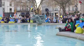 People watch stage with fountain at the London Stands with Ukraine: March and Vigil another view