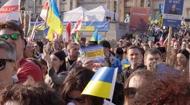 People holding Ukraine flags at the London Stands with Ukraine: March and Vigil