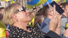 Woman filming the stage at the London Stands with Ukraine: March and Vigil