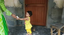 A cute village girl is playing with her sister. She is running for playing.