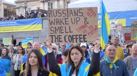 People with placards watching the stage at London Stands with Ukraine: March and Vigil