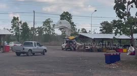 Sudden gust of wind blows tent onto electricity wires during storm in Thailand