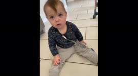 'Cheerful baby boy in TOTAL SHOCK after mischievous cockapoo tramples on him '