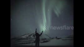 Northern Lights light up the sky amid in windy weather in Dalvik in northern Iceland