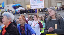 Woman waving anti war flag at the London Stands with Ukraine: March and Vigil
