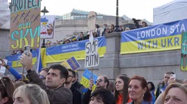 A person holding 'Stop Putin' placard at the London Stands with Ukraine: March and Vigil