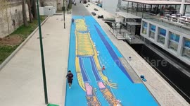 40m long fresco in the colors of the ukraine flag. The name : Bonhomme flottant (Floating man); by the street artist Alexone Dizac. Paris. France, on the ground of the Port du Gros Caillou, along the Seine River. 29 apr 2022.  Plus, other homages in Paris