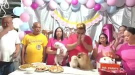 Puppy falls from buffet table while family poses for birthday photo