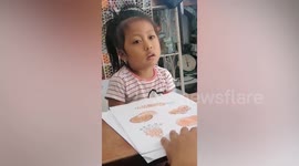 Little girl argues with mother after she is made to read a word repeatedly