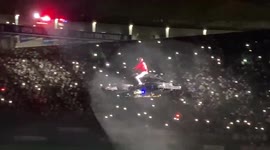 Japanese baseball team manager flies around stadium on drone bike during opening ceremony
