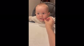 'Cute baby HAS NO IDEA what to do after puffs stick to his lips '