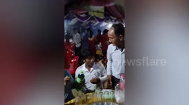 Wedding guests sit under leaking tent as storm hits ceremony in Cambodia