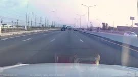Box falls from speeding pickup truck in Thailand