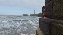 Sea waves at Whitby Harbour beach in Whitby North Yorkshire England UK