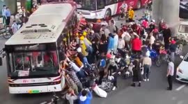 Dozens of passersby lift bus up to free man trapped underneath in southern China