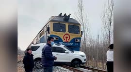 Crane used to remove vehicle that collided with cargo train in China