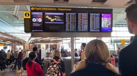 Passengers wait for further info on their delayed flights, as  BA customer service desks deserted at Heathrow T5