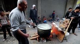 A Palestinian man distributes free food for Poor families on the first Day of the Muslim fasting month of Ramadan, in al-Shijaiyah neighborhood in Gaza city.
