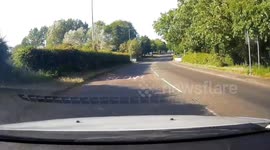 Dangerous driver runs a red light caught on Dash cam.  Drives straight through